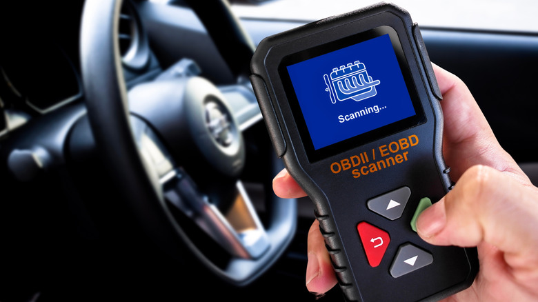 An OBDII Scanner being used to check vehicle fault codes.