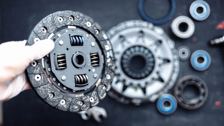 Car transmission clutch kit held in hand