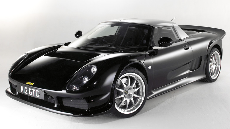 A black Noble M12 convertible with the top up against a white background.
