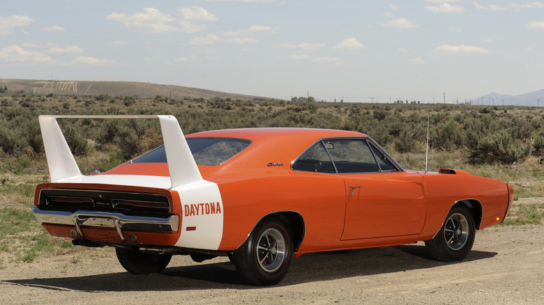 The Dodge Charger Daytona in orange pictured from the rear with a white rear deck-wing.