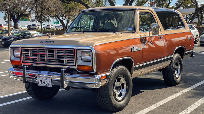 A tan and brown Dodge Ramcharger in a parking lot.