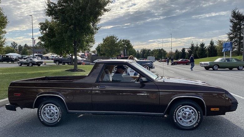 A side view of a dark brown Dodge Rampage parked on the street.