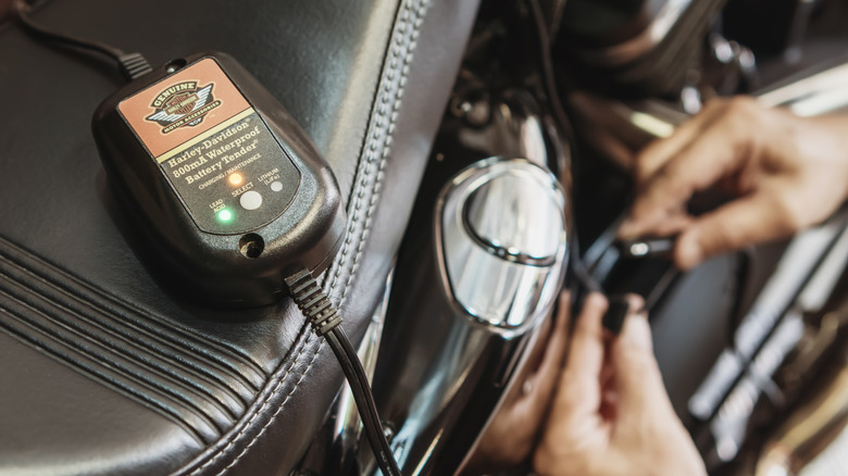 A branded battery maintainer is attached to a motorcycle.