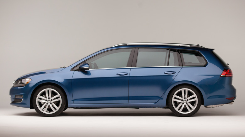 Blue 2015 Volkswagen Golf TDI SportWagen press photo with a neutralbackground