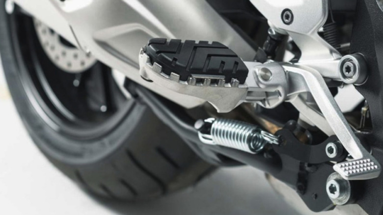 Adjustable motorcycle footpegs are shown up close.