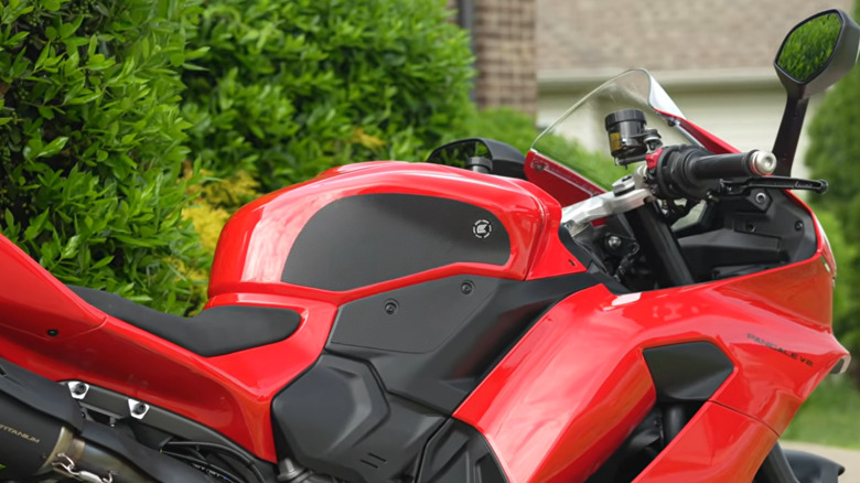 Tank grips shown on a red motorcycle.