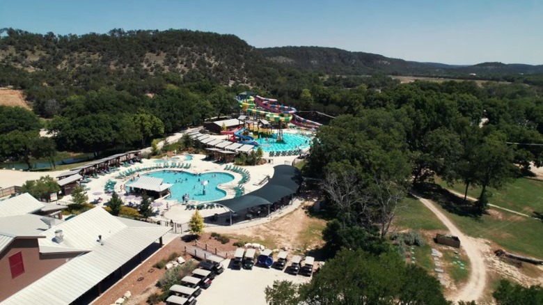 Aerial view of Camp Fimfo featuring multiple pools and mountain scenery