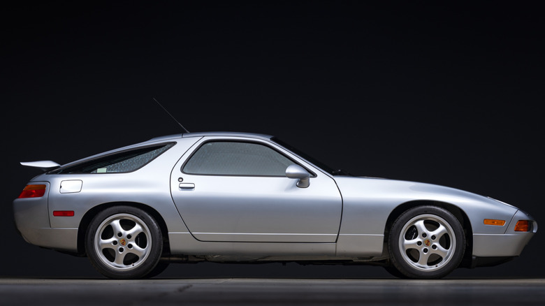 Silver Porsche 928 side profile with black background