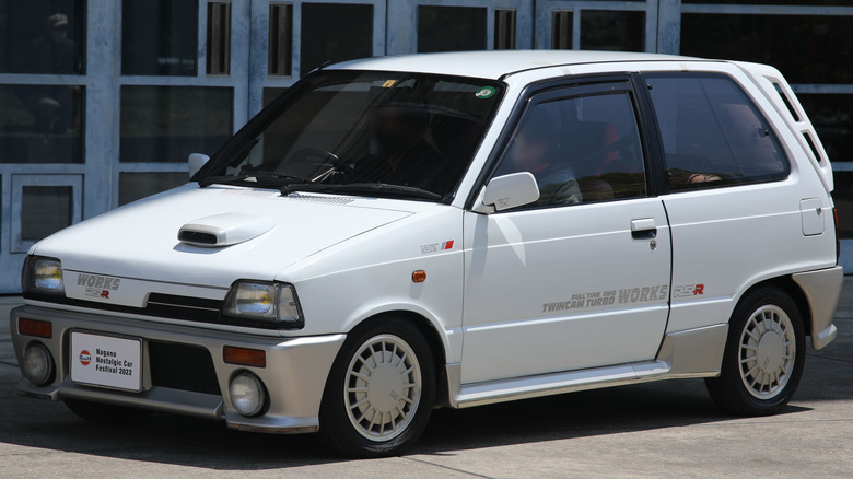 A Suzuki Alto Works RS-R in front of a building