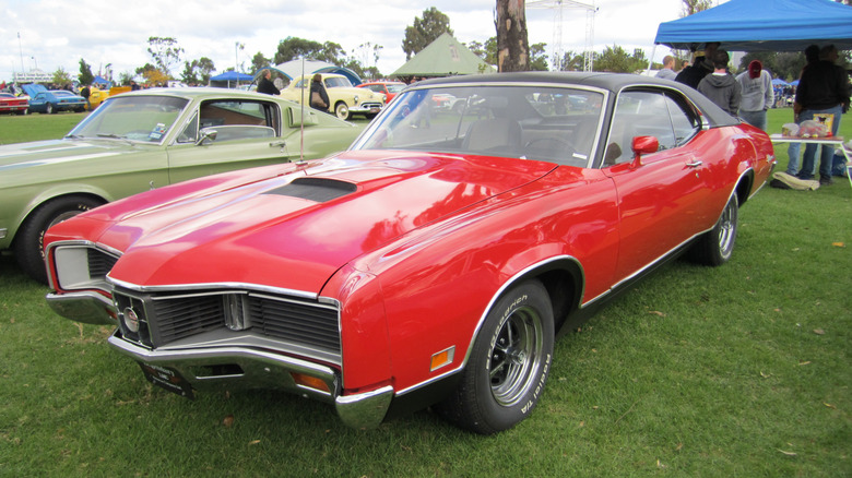 Red 1970 Mercury Cyclone coupe left front three-quarter view parked at outdoor car show