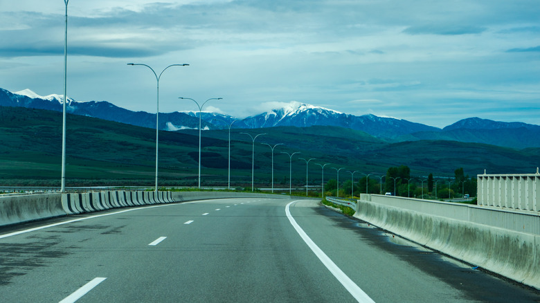 European Route E60 in Georgia, with mountains in background.