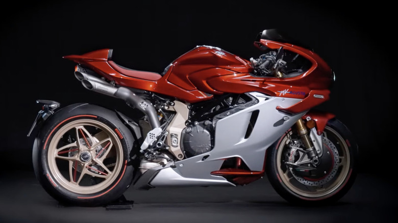 A new 2025 MV Agusta Superveloce 1000 Serie Oro in a showroom setting on a black floor with a black background.