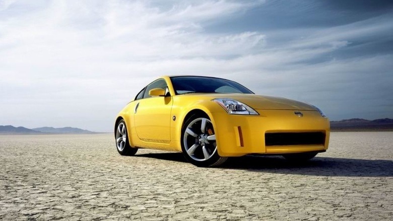A yellow 350Z sits parked on a salt flat under a huge sky.