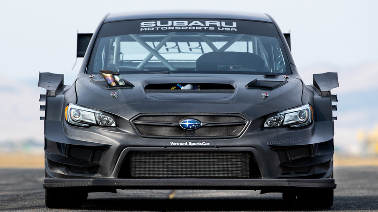 A heavily-modified WRX STI is viewed from the front.