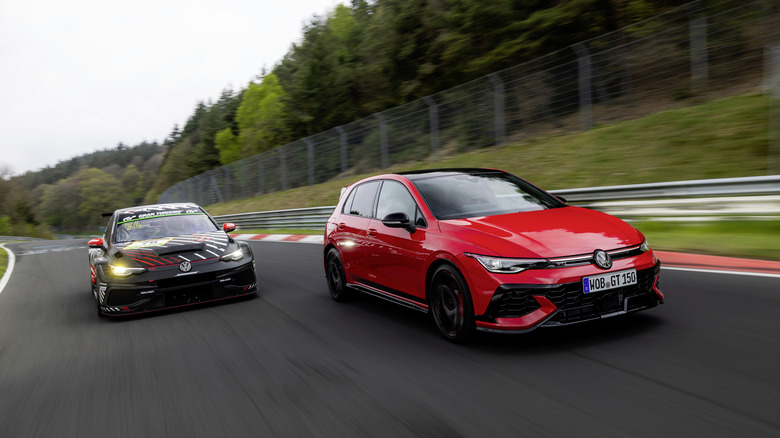 Two Golf GTIs race side by side on a track.