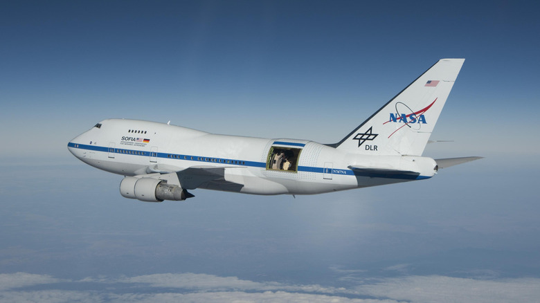Boeing 747SP SOFIA astronomy plane seen from left rear in flight with telescope door retracted