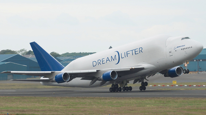 Boeing Dreamlifter cargo jet seen from front left at takeoff