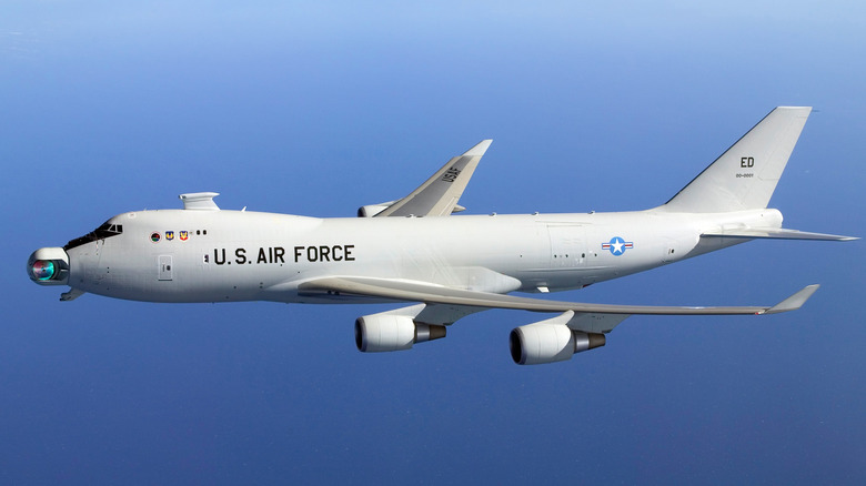 Boeing YAL-1 Airborne Laser Test Bed seen from above left in flight over water