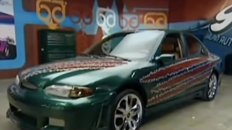 Ellyn's 1996 Ford Contour with green paint and claw graphics