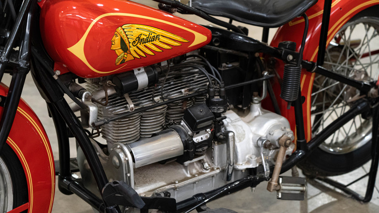 The engine of a red 1936 Indian upside-down four-cylinder motorbike.