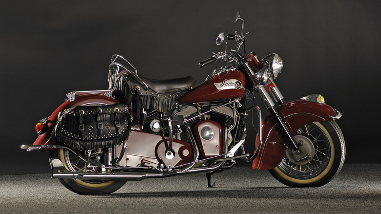 A pristine deep-red 1953 Indian Big Chief motorcycle against a black background.