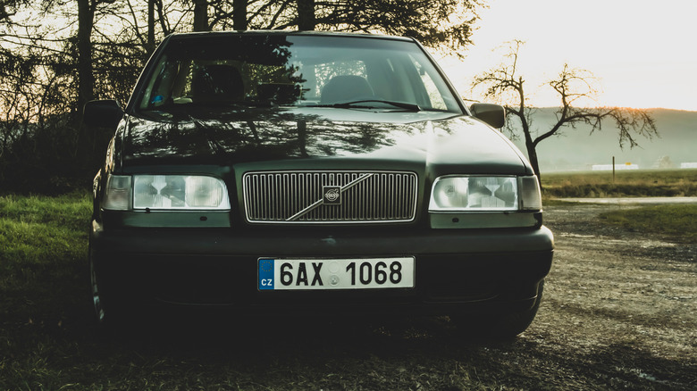 A front view of a Volvo 850 parked outside.
