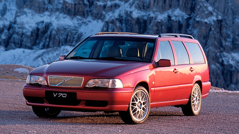 A red Volvo V70 parked outdoors.