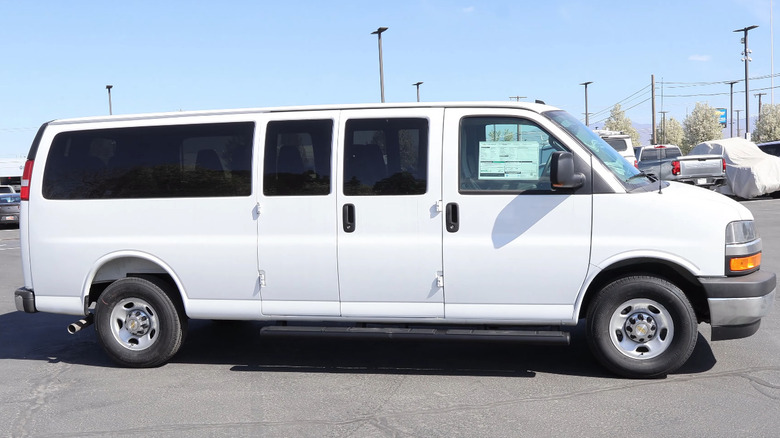 Side view of 2026 Chevrolet Express Passenger Van in white