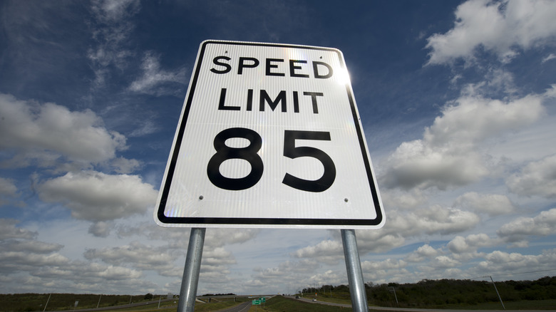 A picture from below of a white speed limit sign, it says 