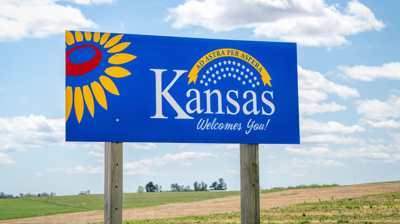 A welcome sign to Kansas, photographed from below.