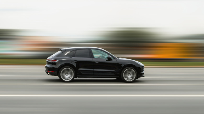 An out-of-focus picture of a car driving on a road.