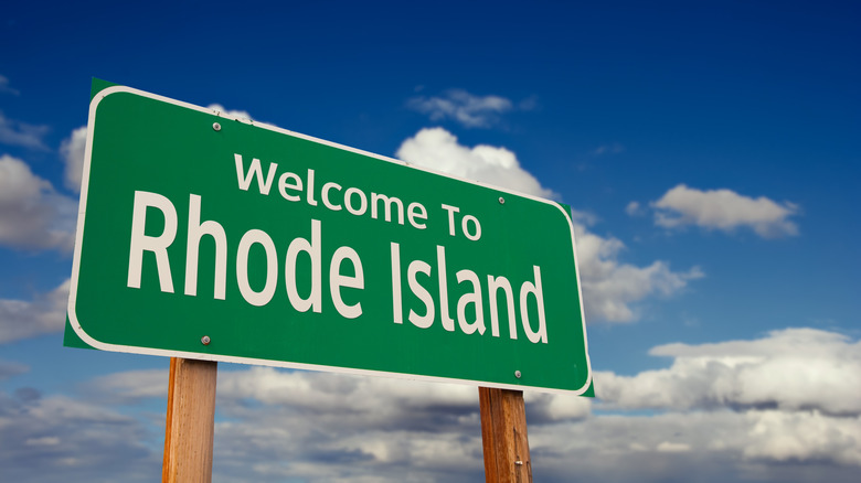 Rhode Island welcome sign with blue sky and clouds
