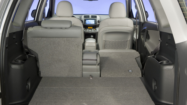 A view from the rear of a third-generation Toyota RAV4 showing a 60/40 split-folding rear seat configuration.