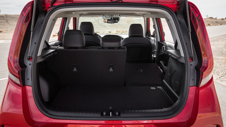 Looking into the hatch of a red Kia Soul, showing the 60/40 split rear seats.