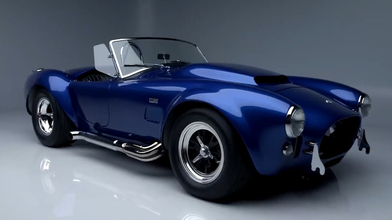 A front 3/4 shot of a metallic blue Shelby Cobra 427 S/C with white stripes.
