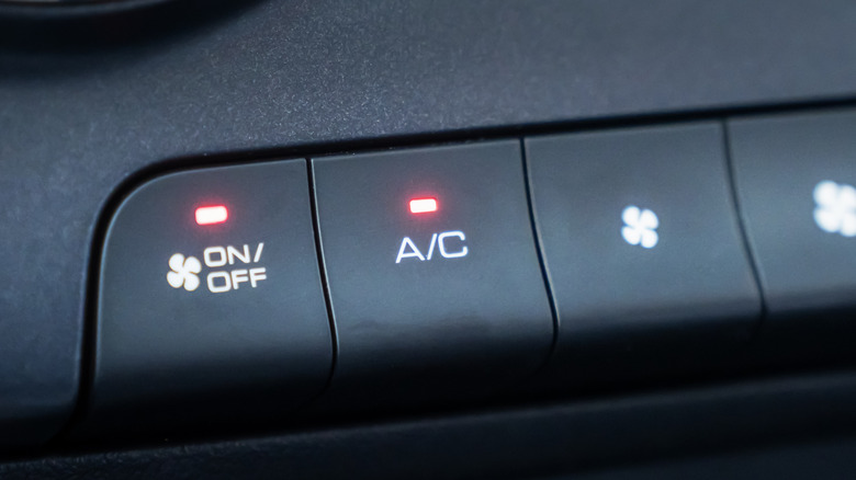 Close-up of A/C button on HVAC controls.