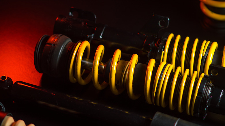 Close up of black and yellow coilovers.