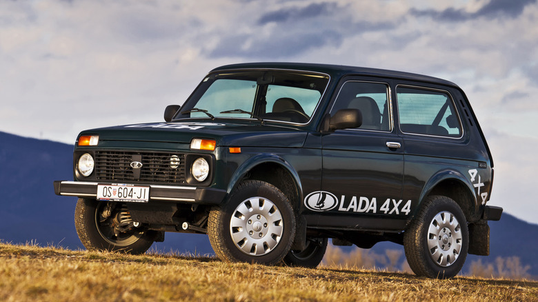 A Lada Niva sits under cloudy skies.