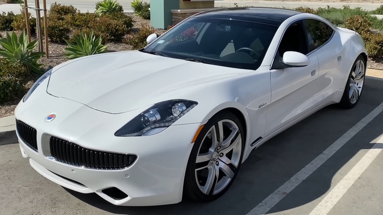 White Fisker Karma sitting in parking space.