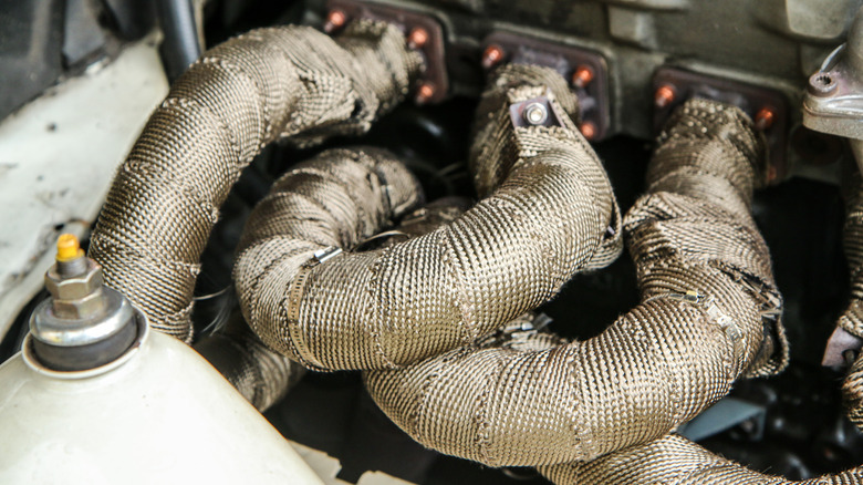 Exhaust manifold wrapped in heat shielding.