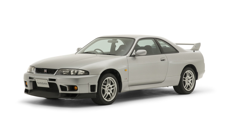 White 1997 Nissan Skyline GT-R V-Spec sports coupe left front three-quarter view in studio