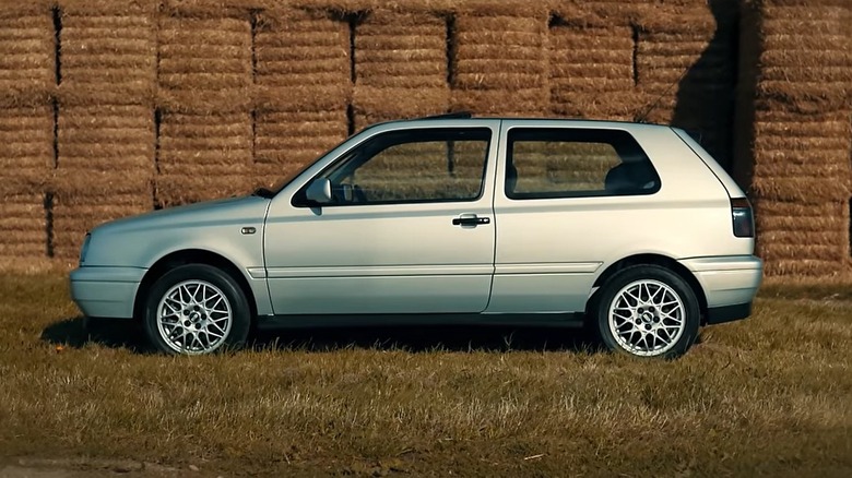Silver VolksWagen Gold GTI VR6 Mark 3 hatchback left view parked in front of hay bales