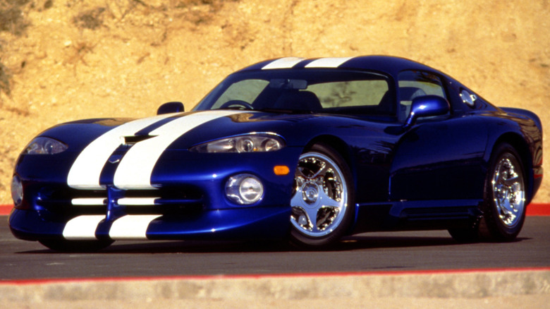 Blue 1997 Dodge Viper GTS Coupe left front three-quarter view parked in front of a dusty hillside