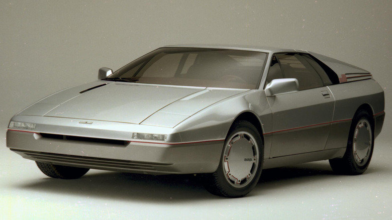The 1984 Ford Maya concept by Italdesign Giugiaro, showcasing its silver wedge profile, low-slung nose with recessed lighting, and aerodynamic flush wheel covers.