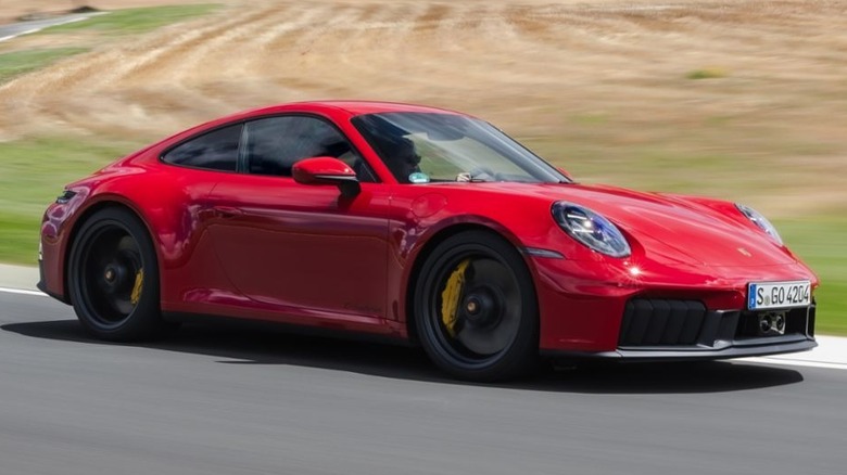 A 2026 Porsche 911 Carrera GTS T-Hybrid cornering on a track