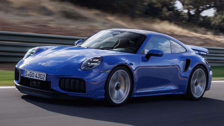 A Lugano Blue 2026 Porsche 911 Turbo S in motion.