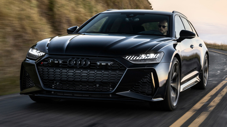 A black 2026 Audi RS6 Avant coming around a curve.