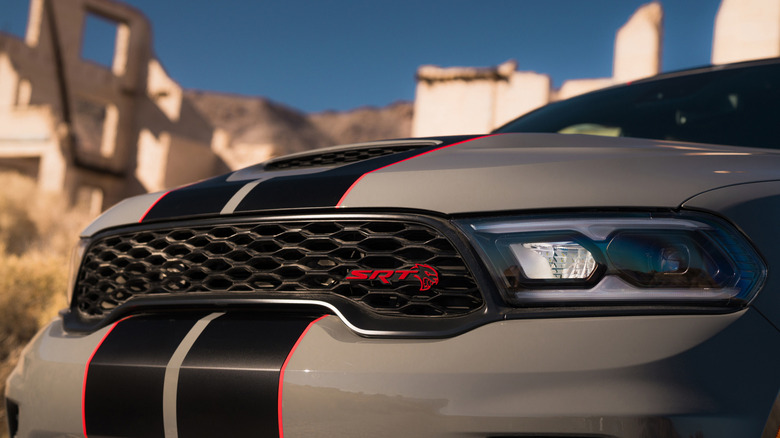 The front of a gray 2026 Dodge Durango SRT Hellcat  with black striping bordered by red