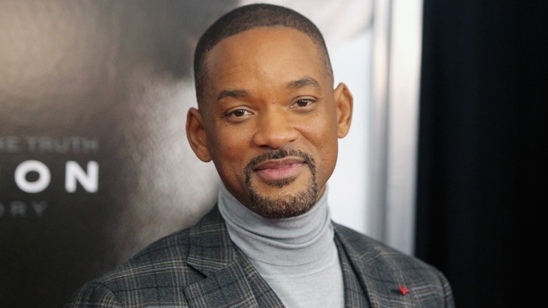 Will Smith smiling at a red carpet event