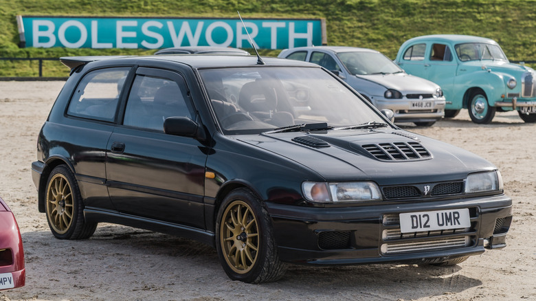 A dark gray Nissan Pulsar GTI-R photographed at a Bolesworth car meet, parked in front of other classic cars.